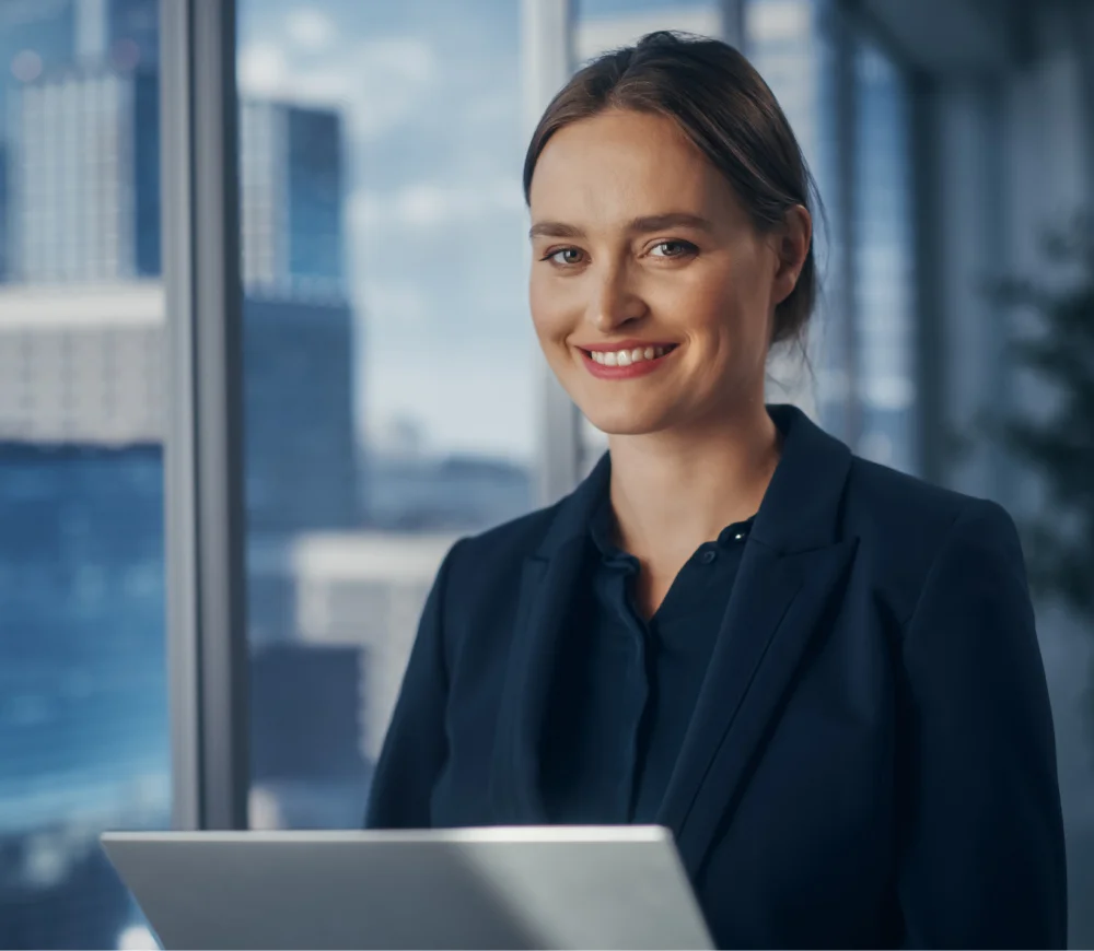 Business woman portrait smiling to the camera with a laptop